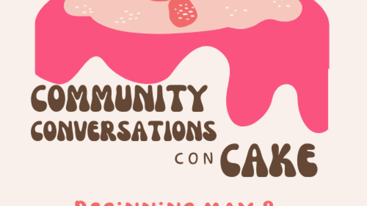 Community Conversations Con Cake, written in brown icing on a pink cake