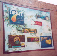 Mural on building of crate labels that are examples of "Fantasy Heritage"