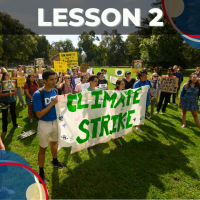 Color photo of a protest with signs that say "Climate Strike"