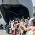 Aghan evacuees boarding military plane. 
